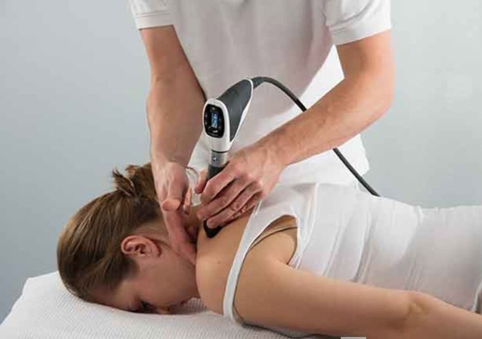 shockwave therapy on woman's shoulder